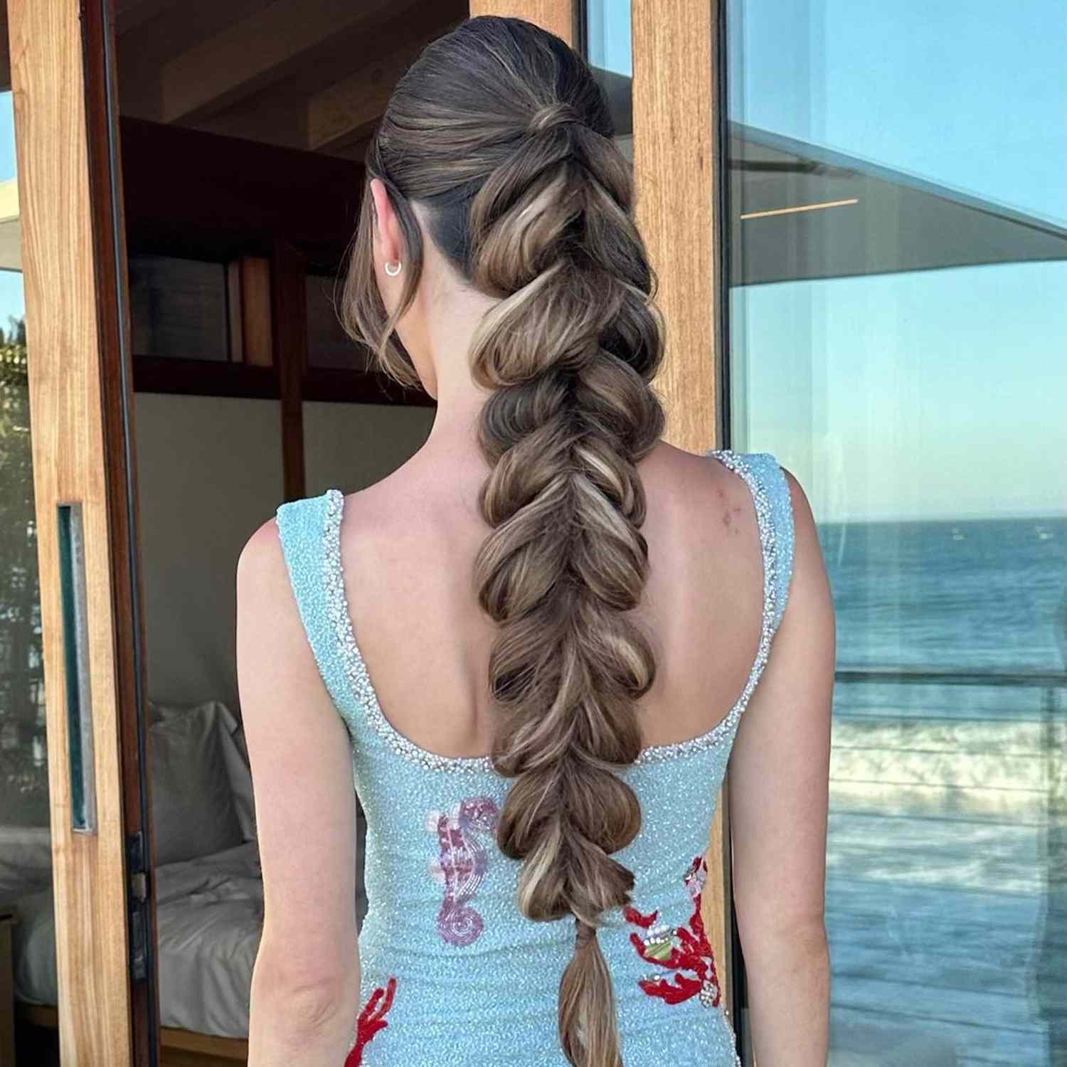 Back view of long, fluffed-out braided ponytail