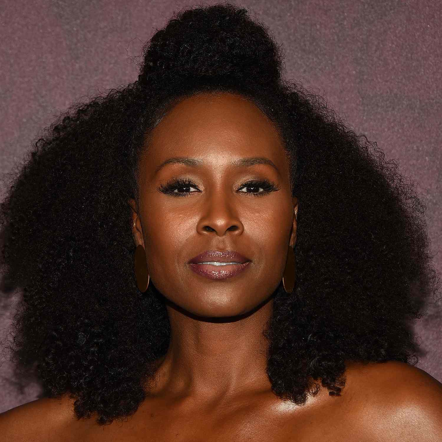 zoomed in picture of Sydelle Noel, with natural afro curls and top section of hair pulled into large bun on top of head