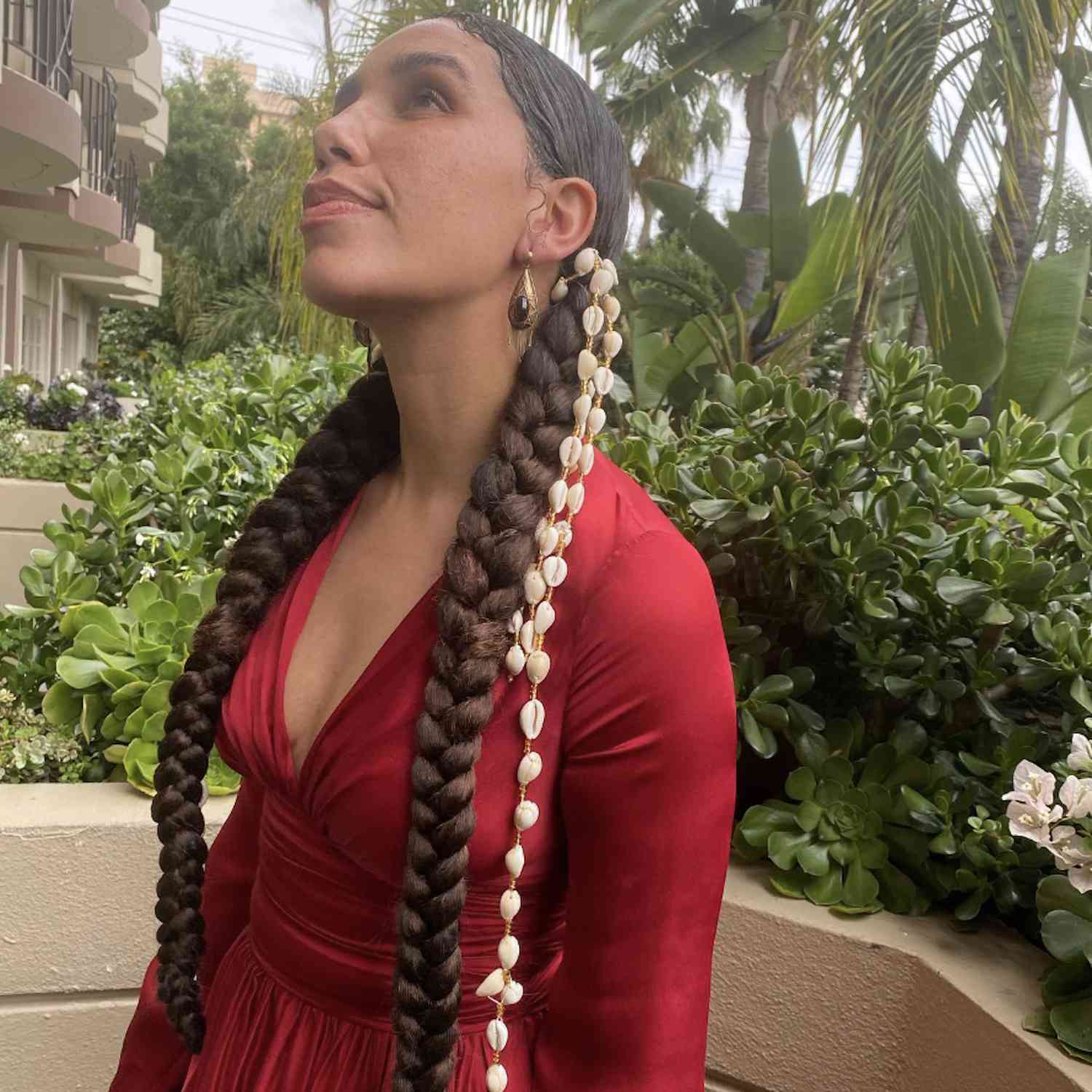 Woman with long braided hairstyle with shell accents
