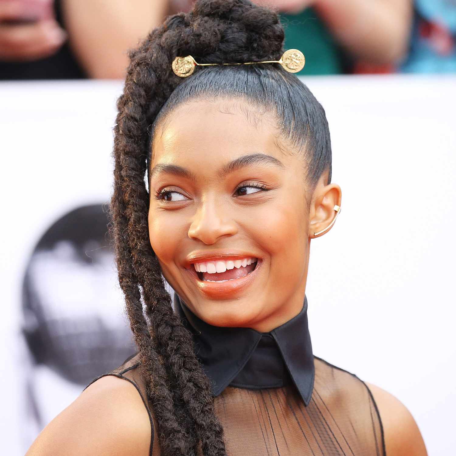 Yara Shahidi wears a high ponytail hairstyle with sleek roots and braided ends
