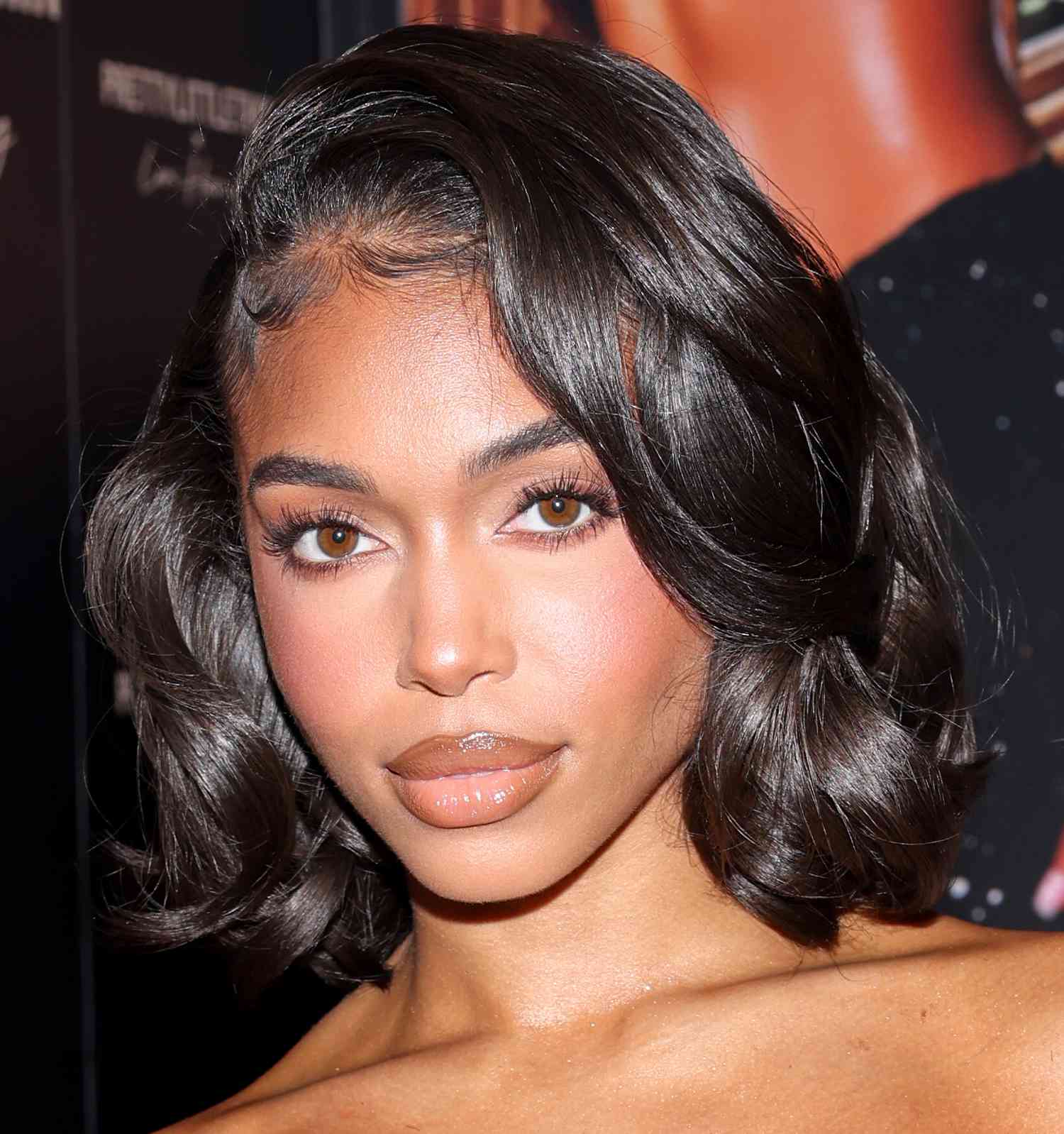 Lori Harvey wears a voluminous curled bob hairstyle to her Pretty Little Thing Partywear launch