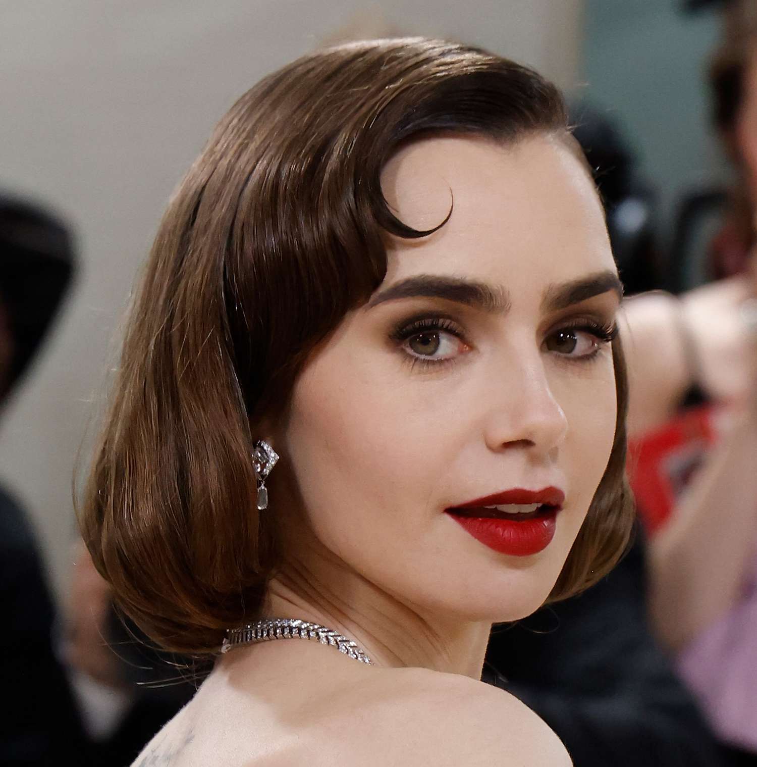 Lily Collins attends the Met Gala with a retro bob and bold makeup