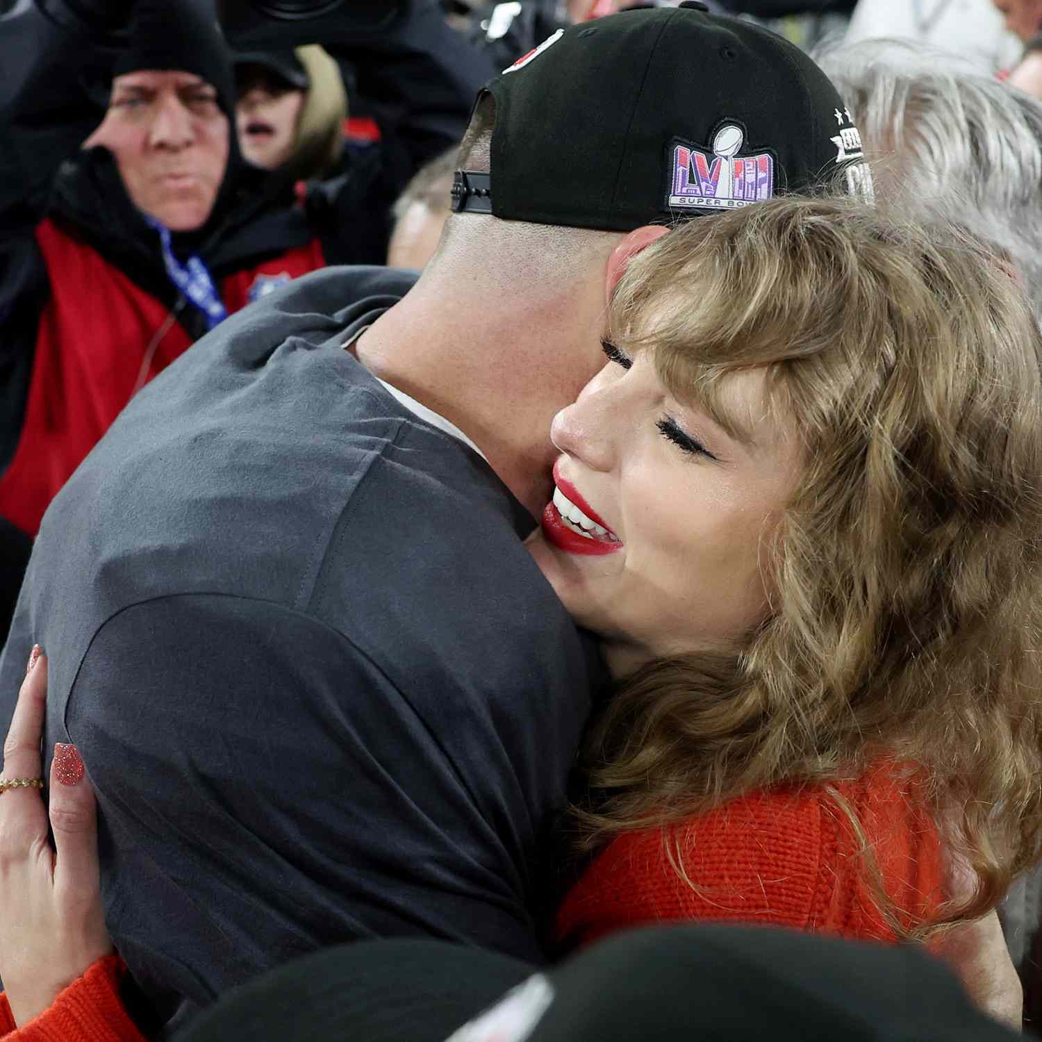 Taylor Swift with reputation curls at the AFC NFL championship hugging her boyfriend travis Kelce