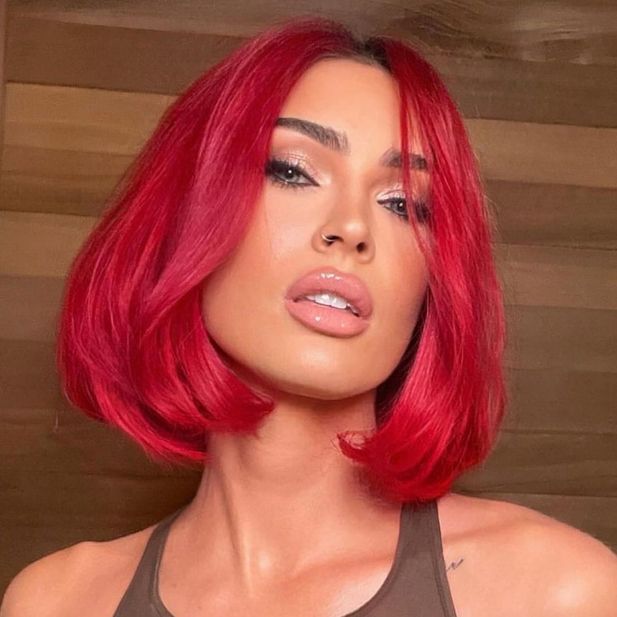 Megan Fox wears a vibrant red bob and pink soft glam makeup look
