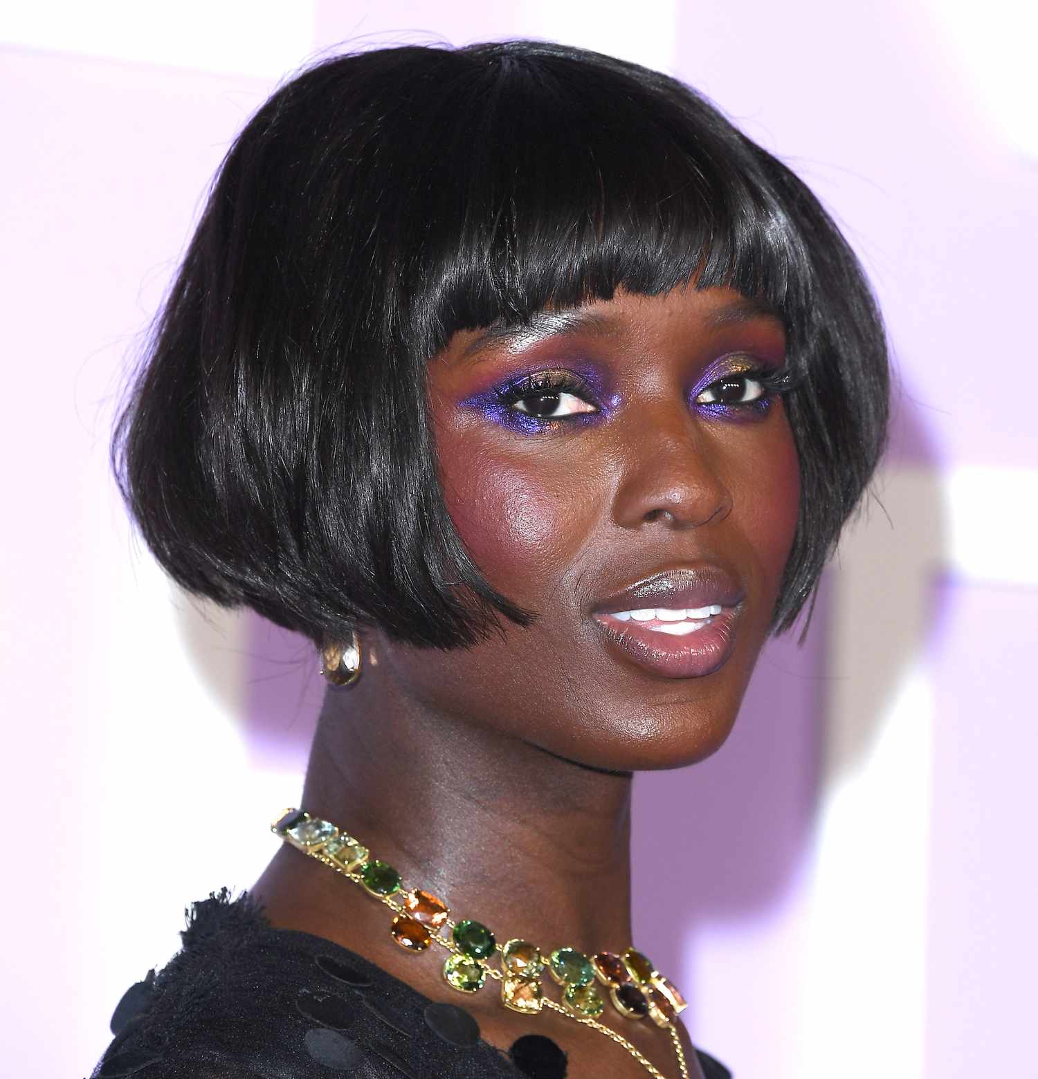 Jodie Turner-Smith on the red carpet with an angular, bouncy micro-bob and purple lined eyes