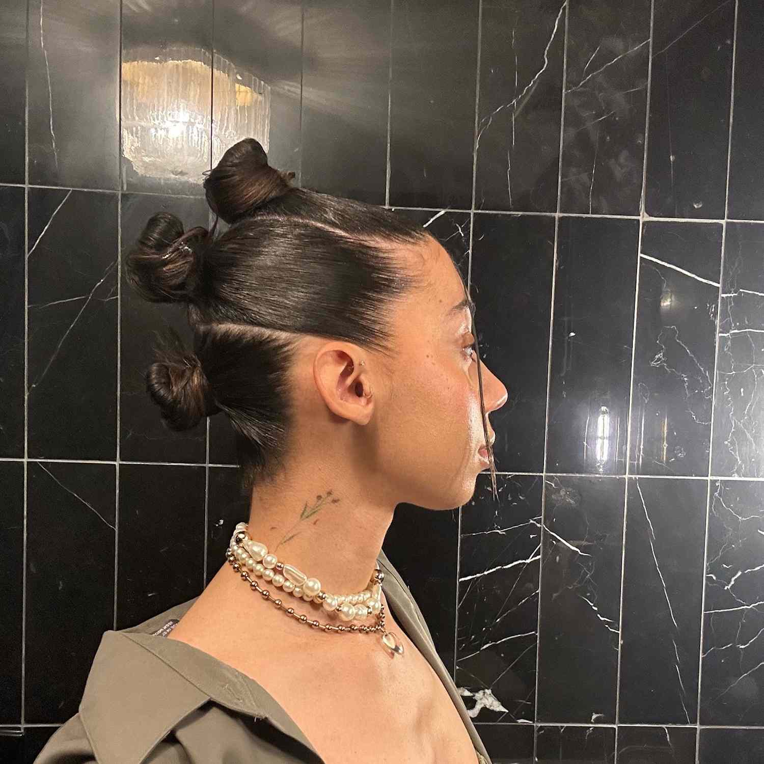 woman with hair slicked back into three buns