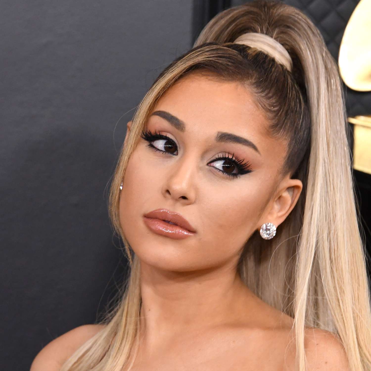 Ariana Grande attends the GRAMMY awards in her signature high ponytail with one short layer down to frame her face