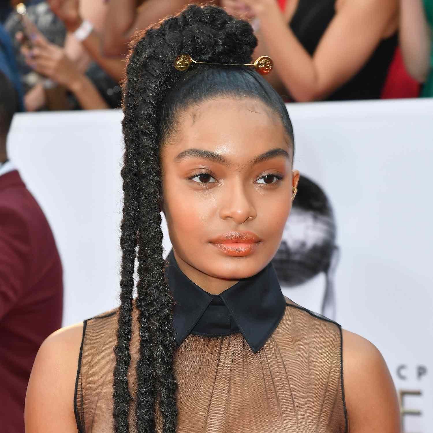 Yara Shahidi wears three braids from the crown of her high ponytail at an NAACP event