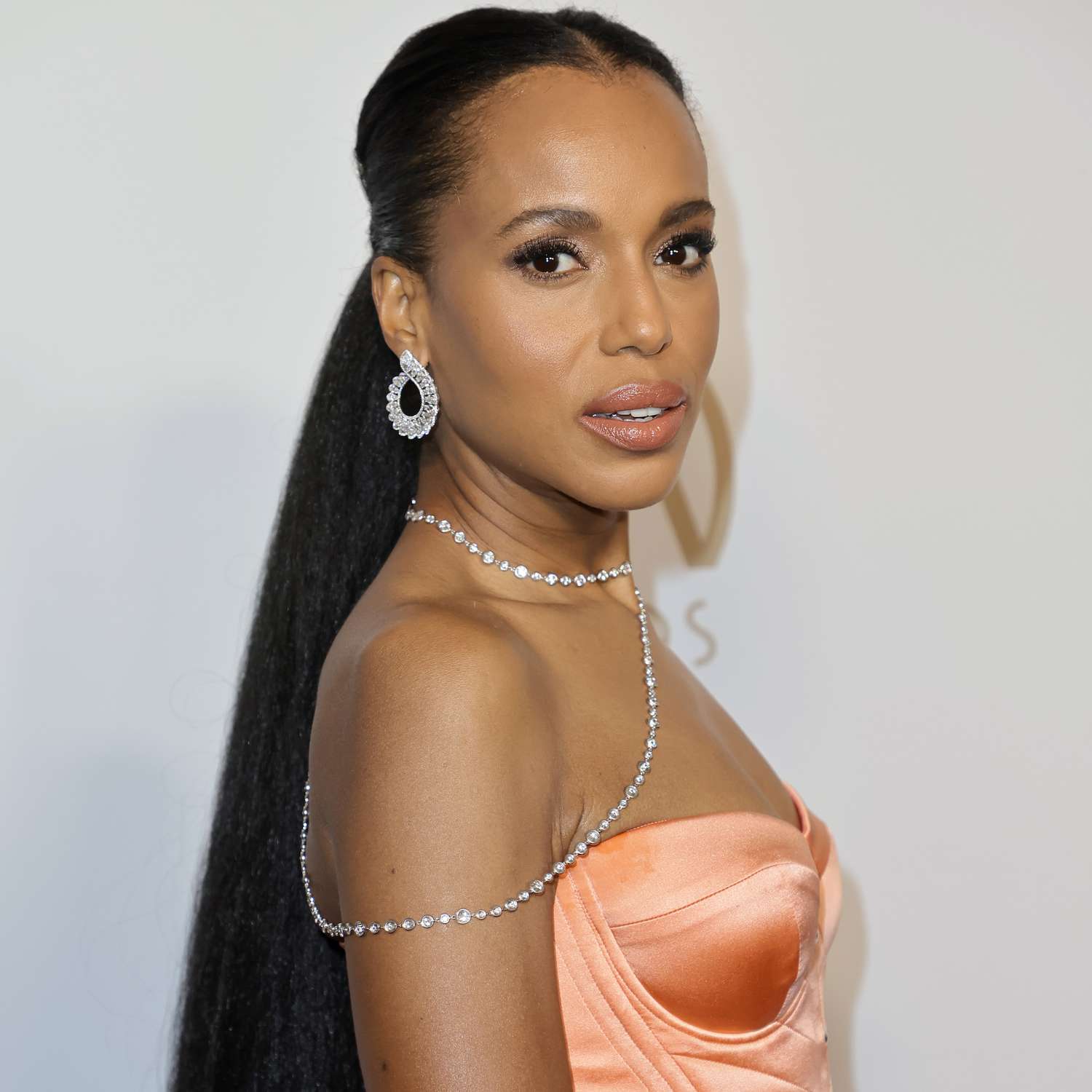 Kerry Washington wears a straight, extra long low ponytail with a center part against her shoulderless dress