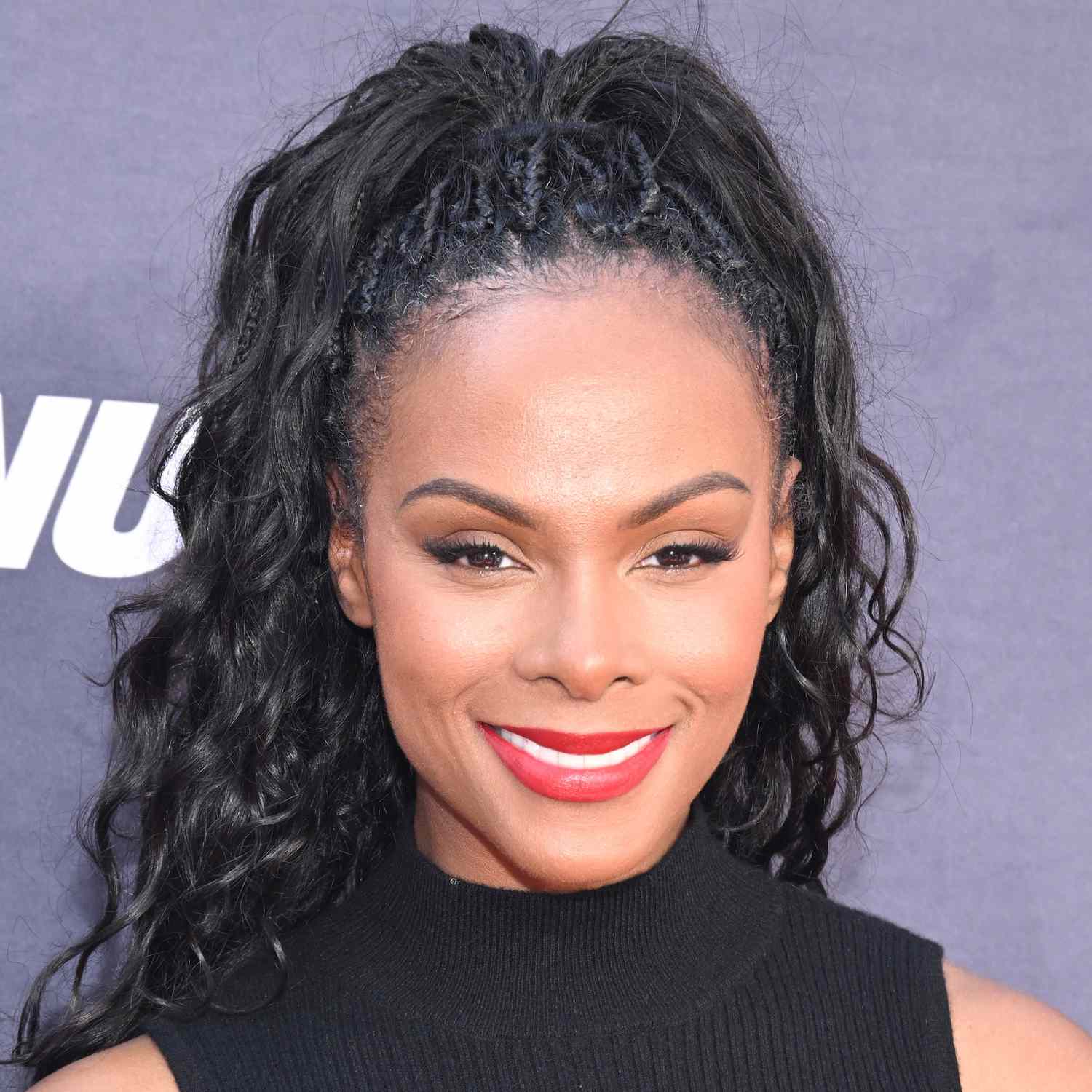 Actor Tika Sumpter wears a high pony of twists and curls to an LA film premiere