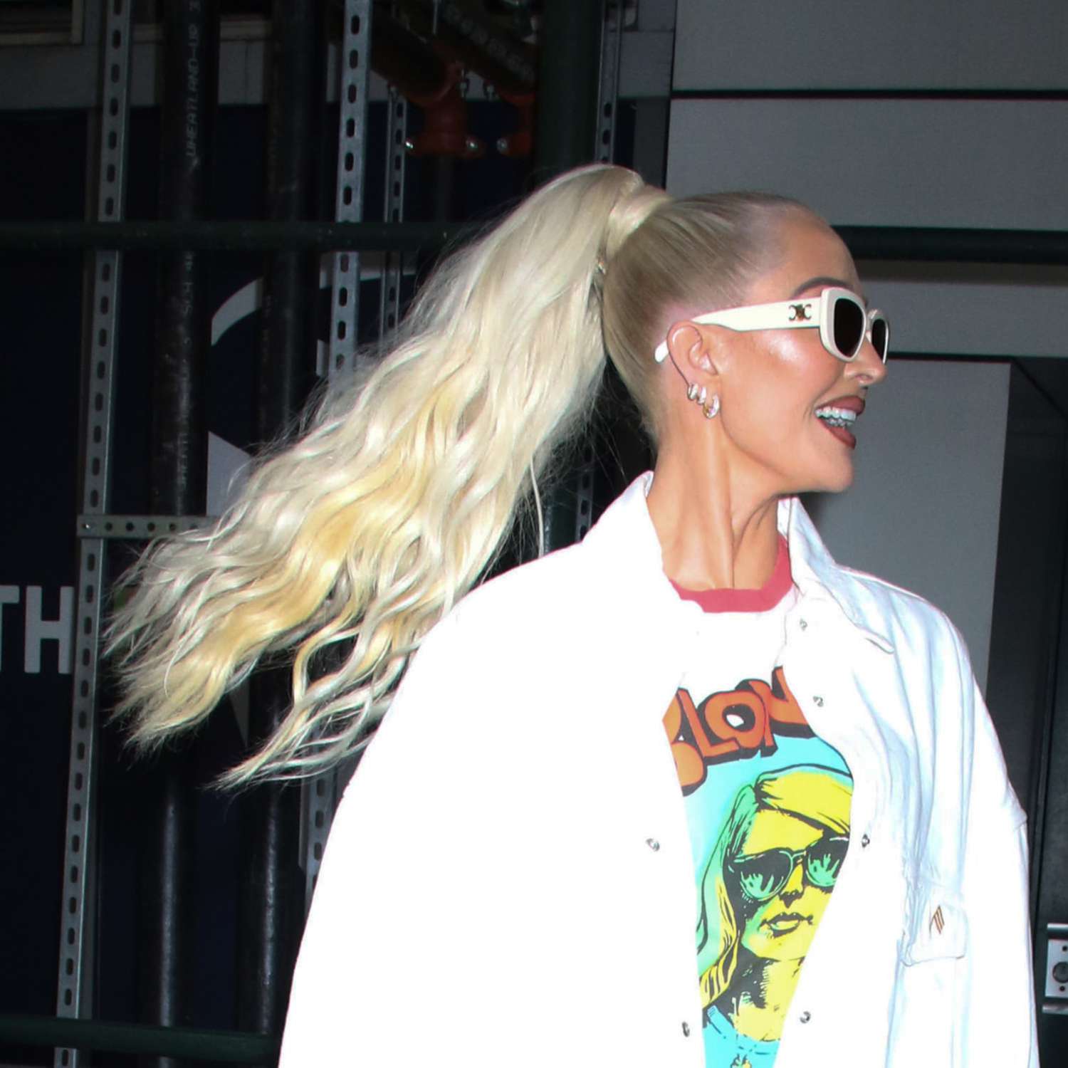 erika jayne with hair pulled back into high wavy blonde ponytail