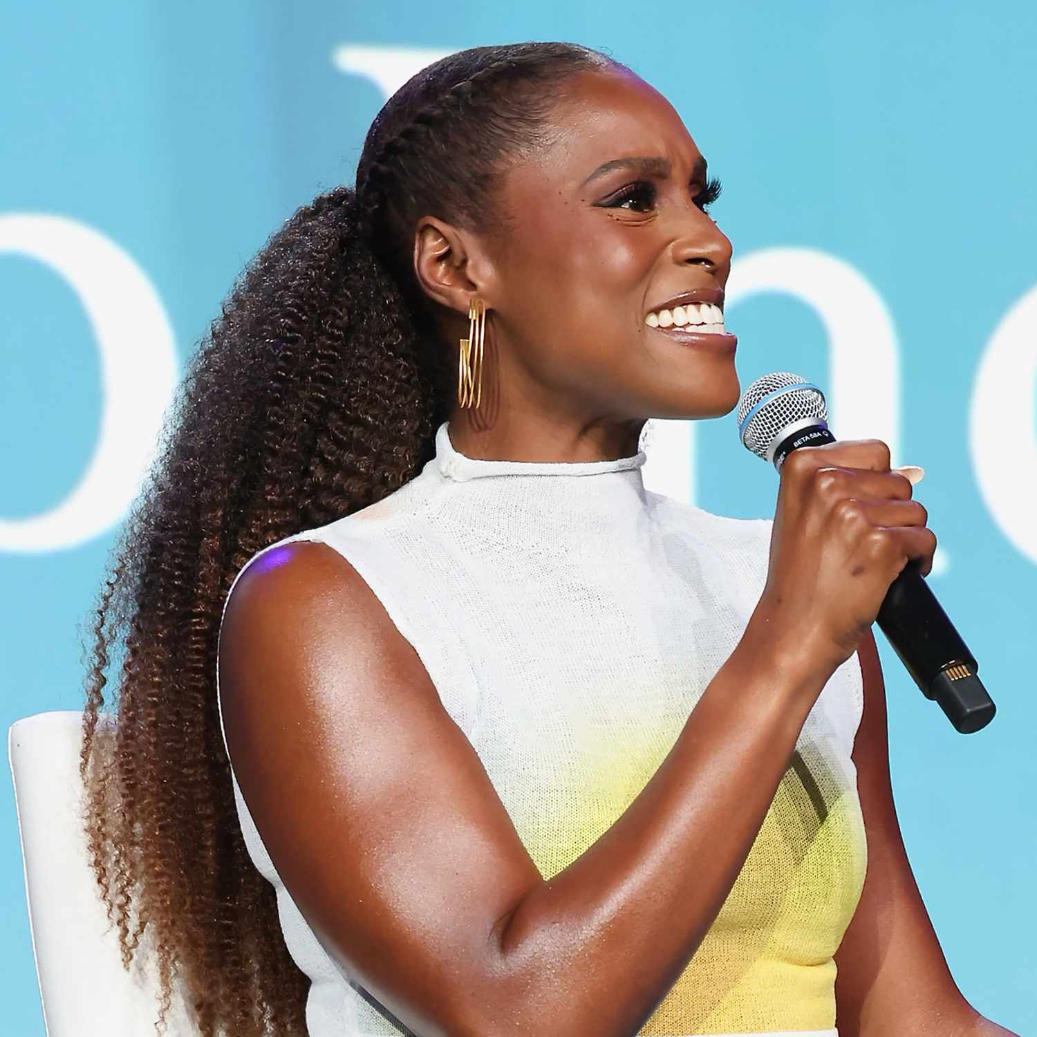 Issa Rae with her hair French braided in the front, a loose, textured ponytail in the back