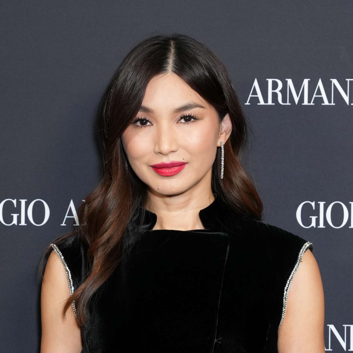 Gemma Chan with brown hair and cherry cola highlights