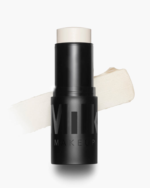 Product shot of Milk Makeup Pore Eclipse Matte Blur Stick with a swipe of the product behind it on a white background.